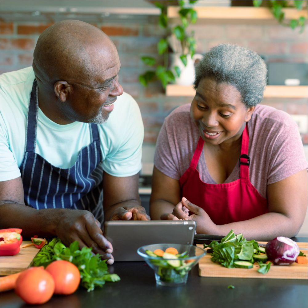 older couple cooking in kitchen